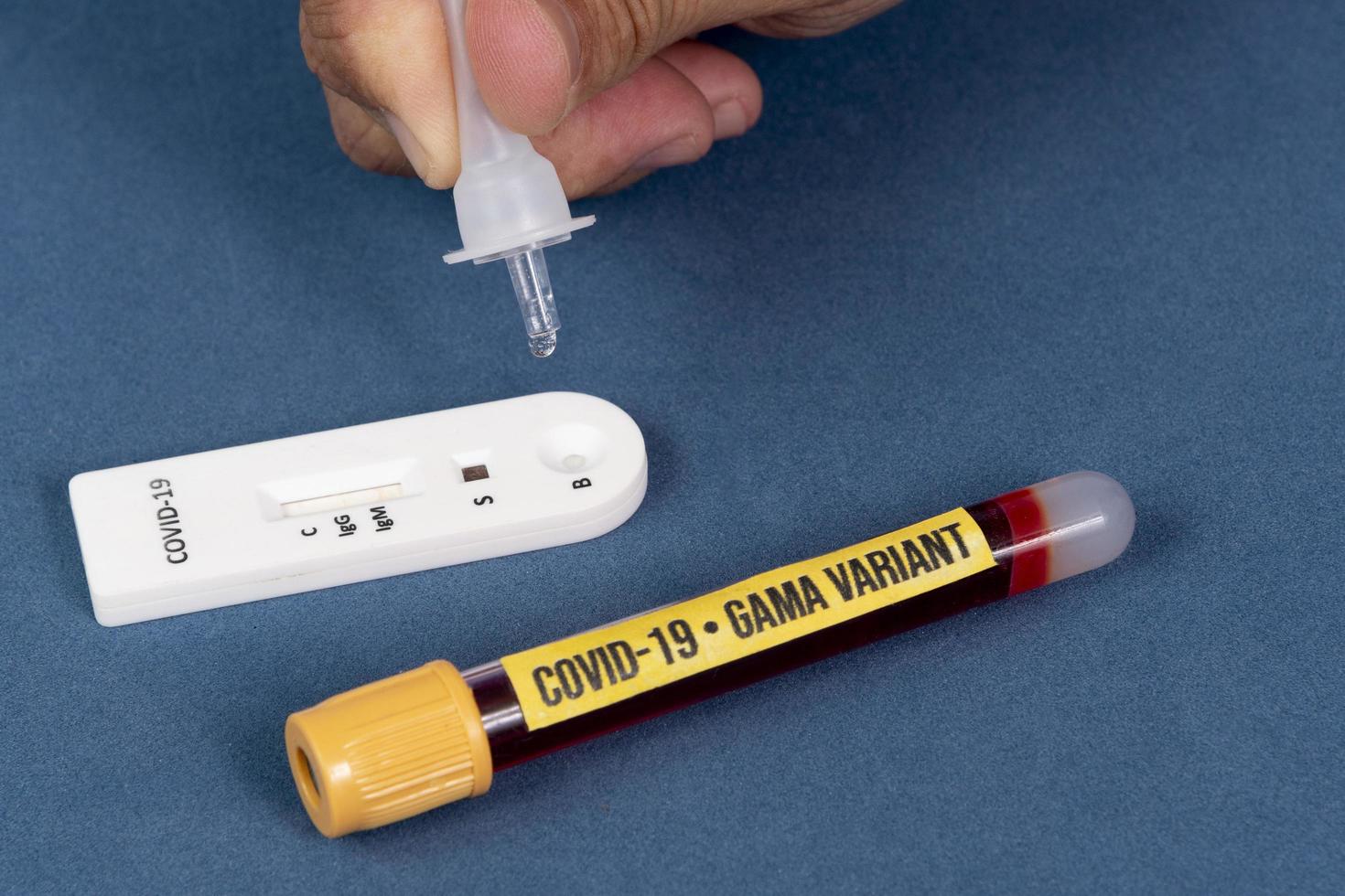 Covid-19 rapid test with person dripping the reagent photo