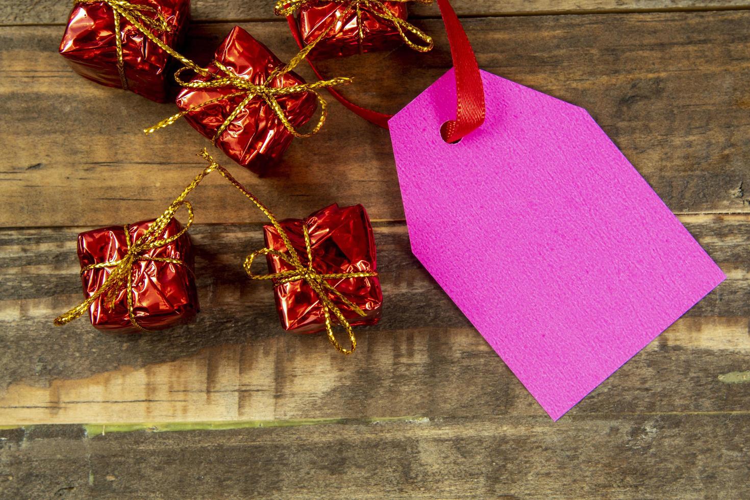 decorative christmas elements next to card with red ribbon and space to write photo