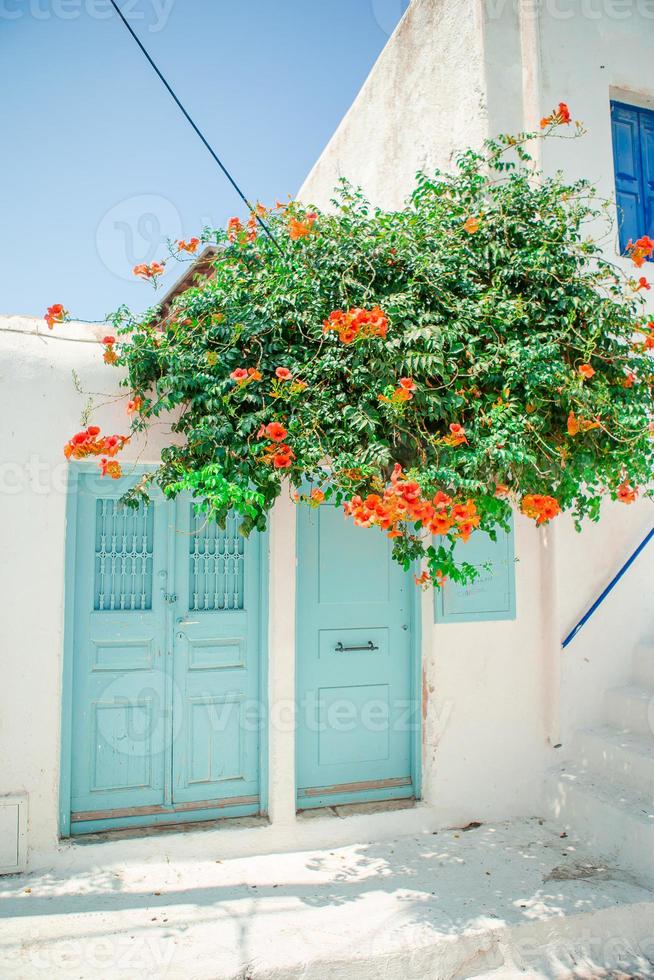 Traditional houses withe blue doors in the narrow streets of Mykonos, Greece. photo