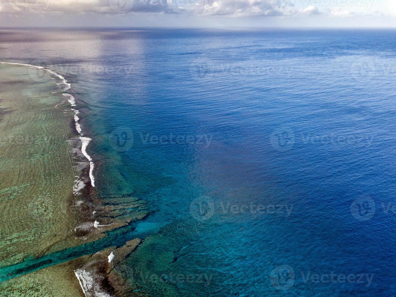 Pacific ocean reef waves Polynesia Cook Island tropical paradise aerial view photo