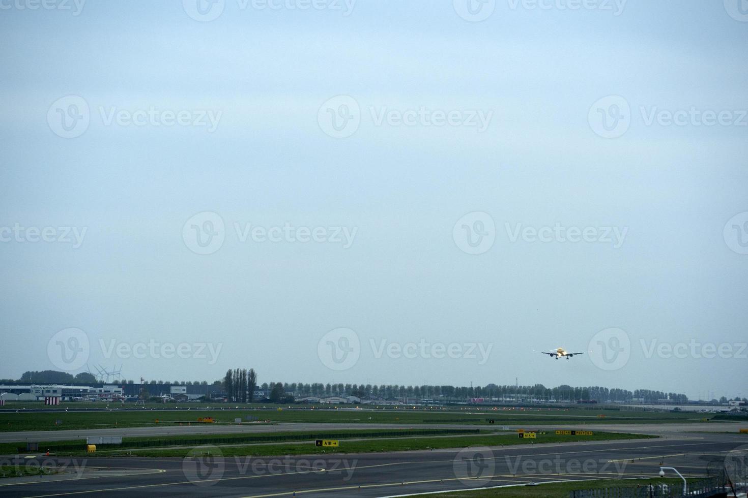 airplane landing at schipol airport amsterdam photo