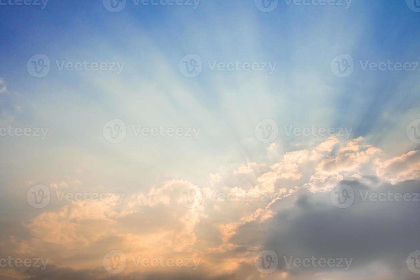 Sunbeam of the sun behind the clouds photo