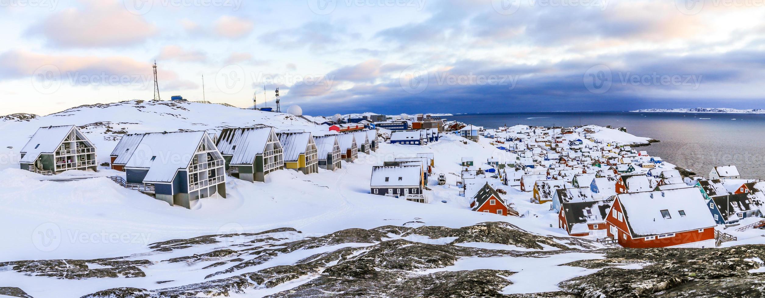 Inuit houses covered in snow. Nuuk city spring panorama, Greenland photo