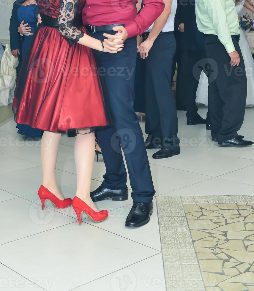 People dancing at the wedding party. focus on legs photo