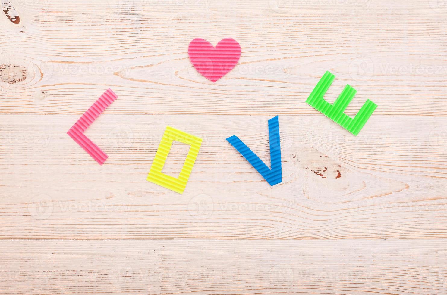 Word love on blue wooden background. Top view photo