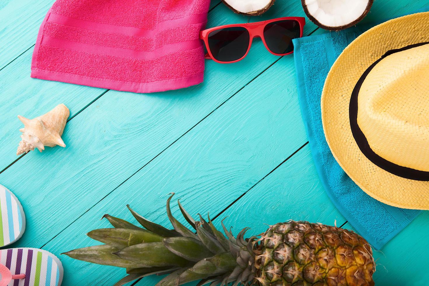 Summer accessories for modern woman on her vacation. Top view. Blue wooden background with copy space. photo