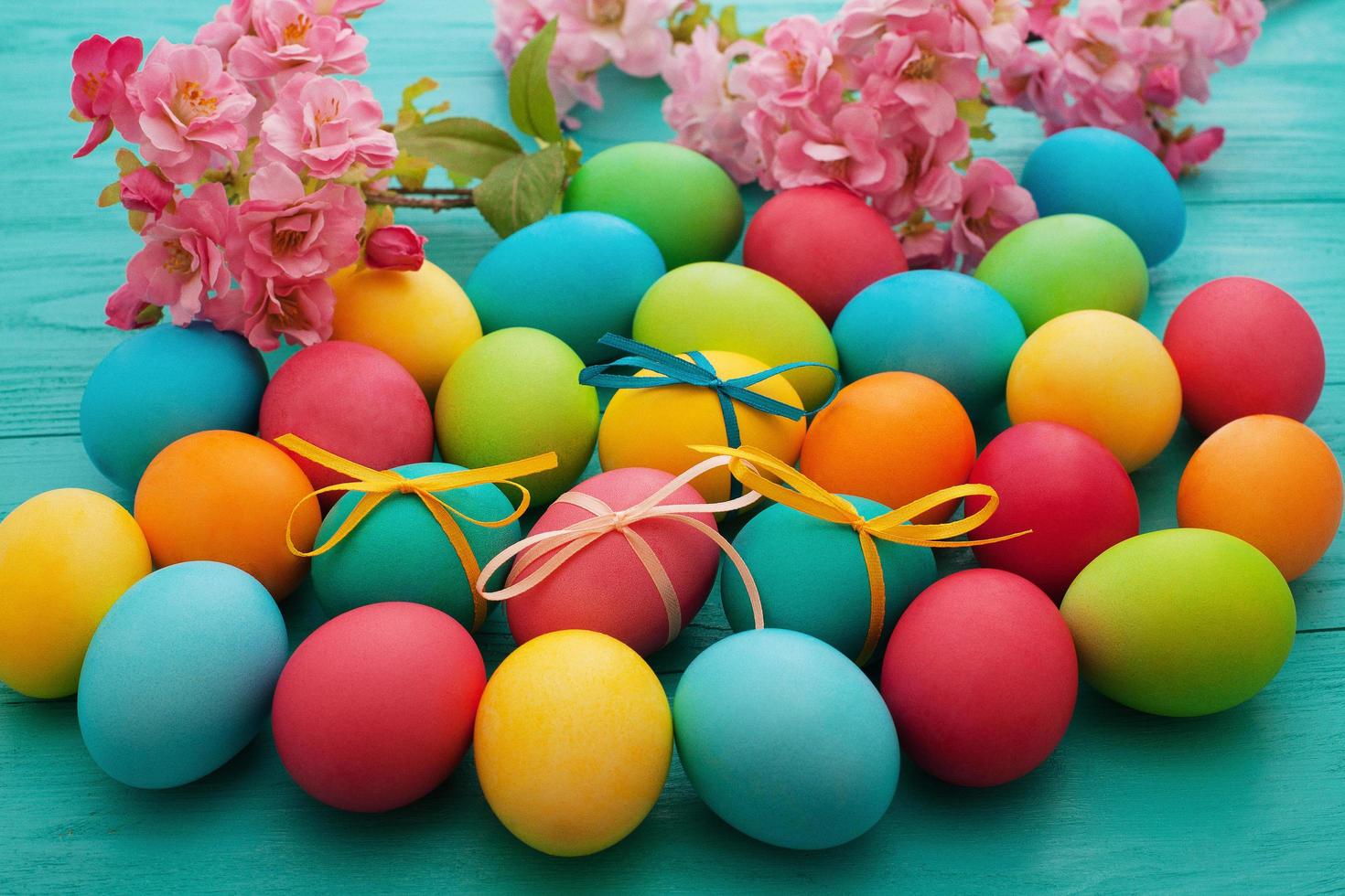 Macro Colorful Easter eggs on blue wooden kitchen table. Egg background. Selective focus photo