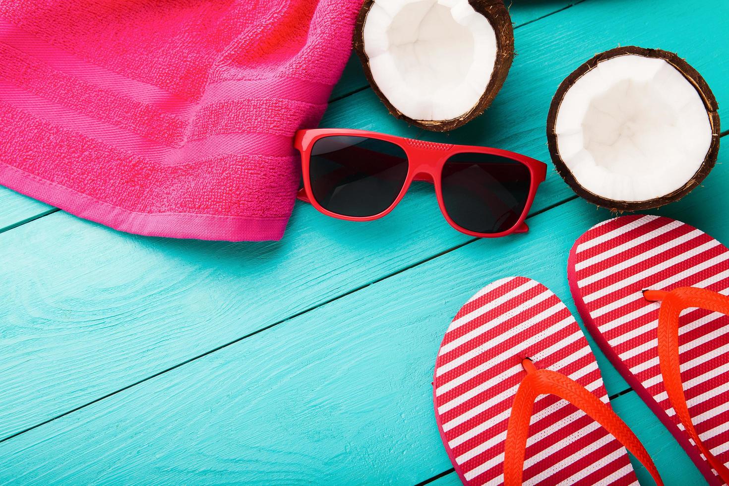 Summer accessories for modern woman on her vacation. Top view. Blue wooden background with copy space. photo