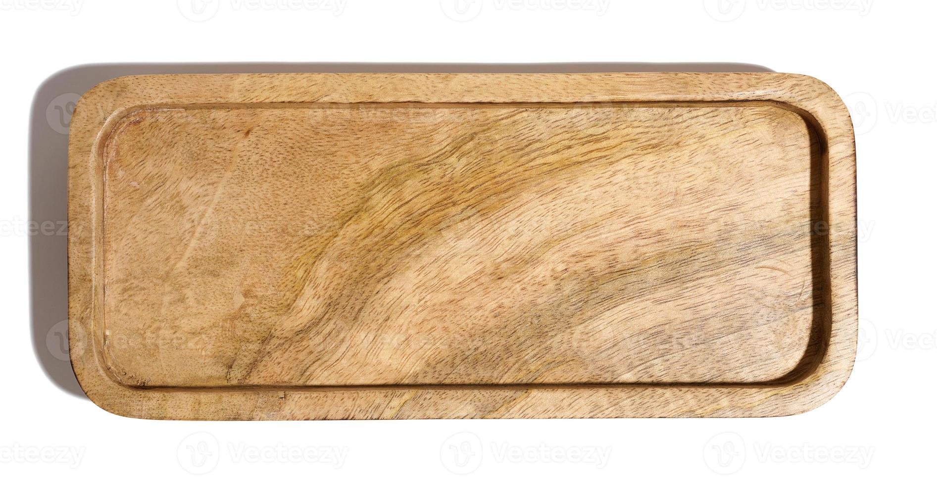 Rectangular wooden plate for serving food on a white isolated background, top view photo