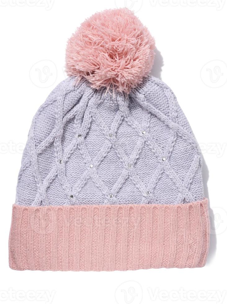 Gray-pink knitted hat with a pom-pom on a white isolated background photo