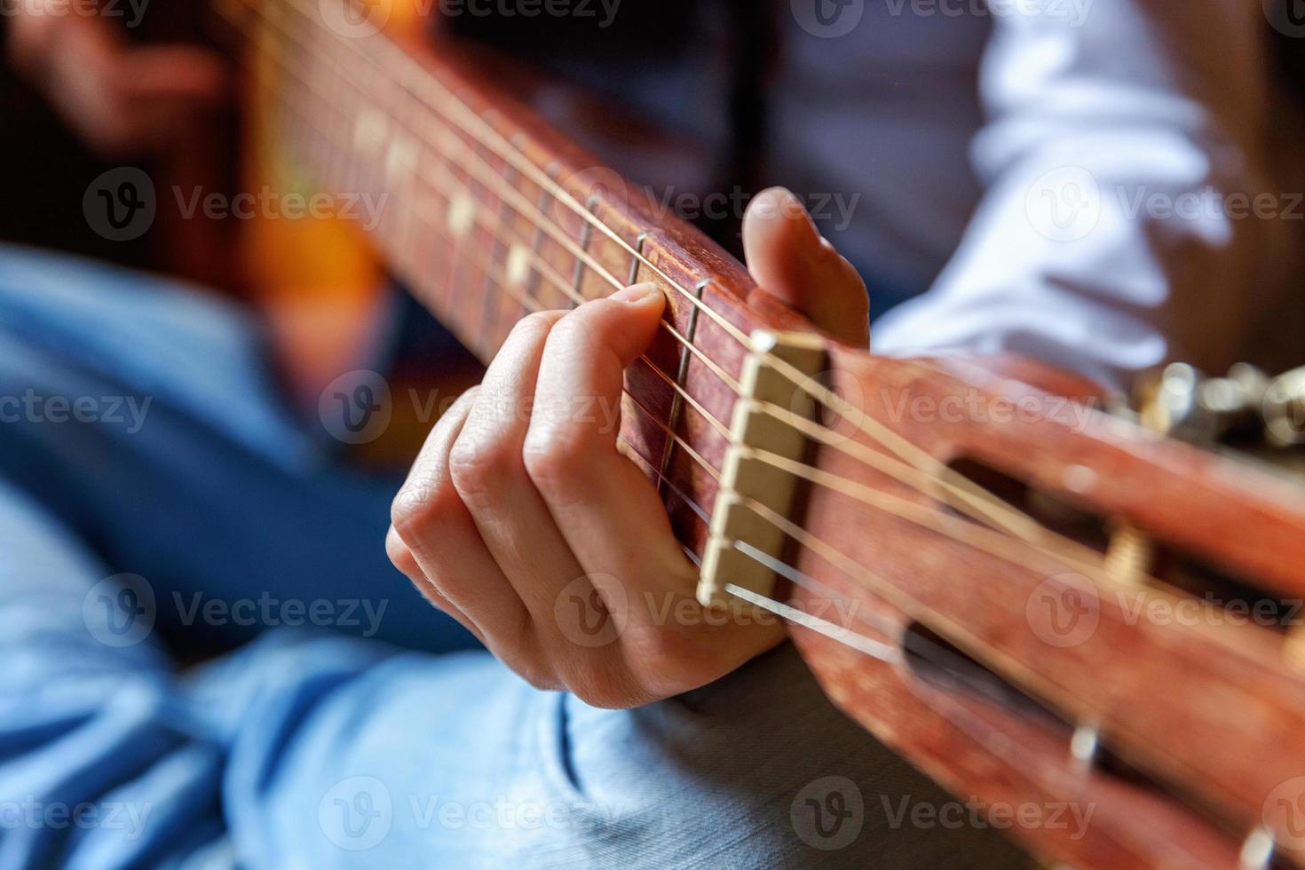 Young hipster woman hands playing guitar at home. Teen girl learning to play song and writing music in her room. Hobby, lifestyle, relax, Instrument, leisure, education concept. photo