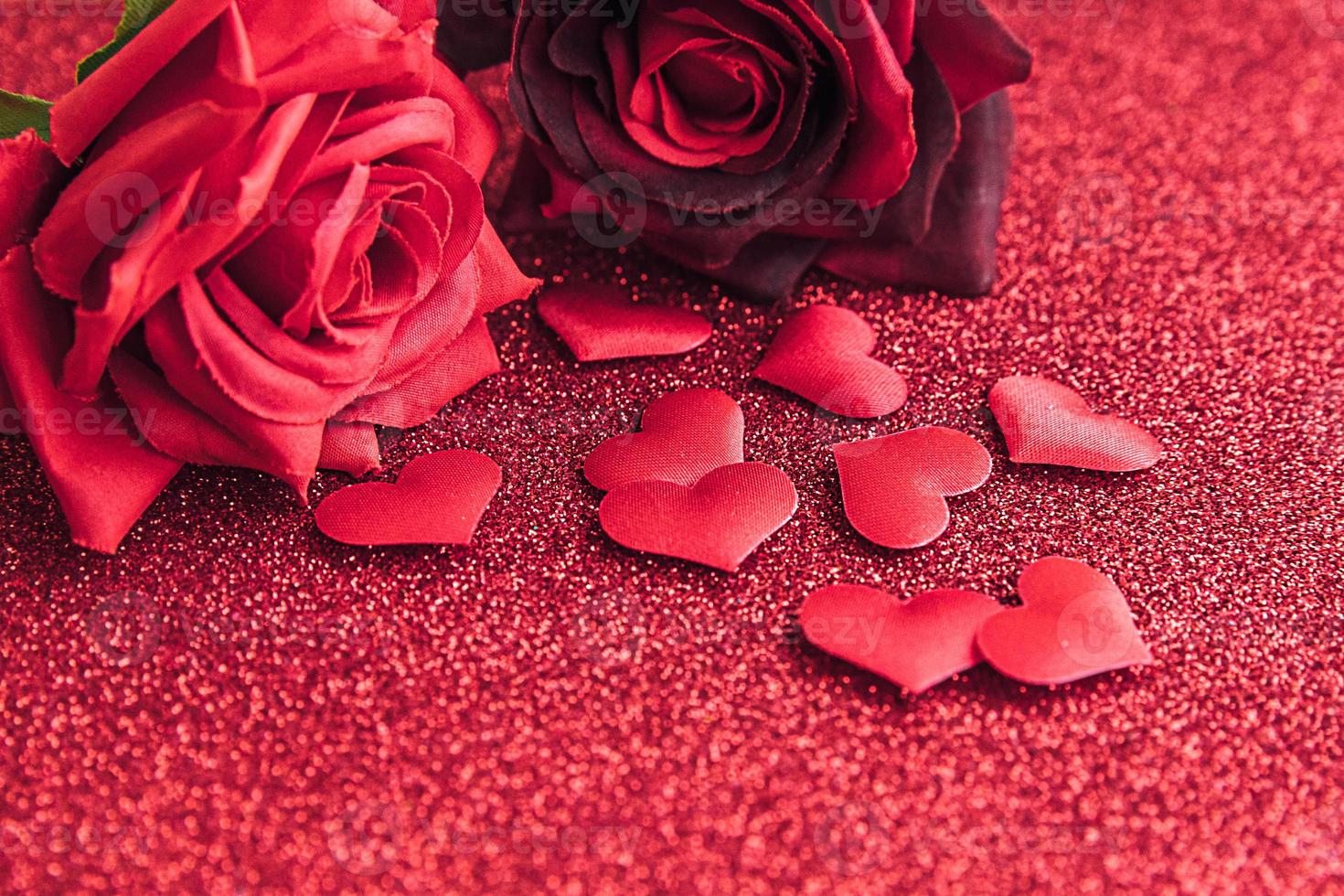 St. Valentine's Day concept. Red scarlet roses and many red hearts on red glitter background. Postcard banner on valentines day. Love date lovesick wedding romance symbol. Valentines day gift. photo