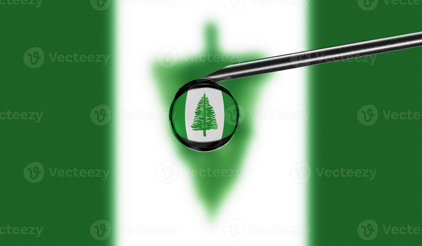 Vaccine syringe with drop on needle against national flag of Norfolk Island background. Medical concept vaccination. Coronavirus Sars-Cov-2 pandemic protection. National safety idea. photo