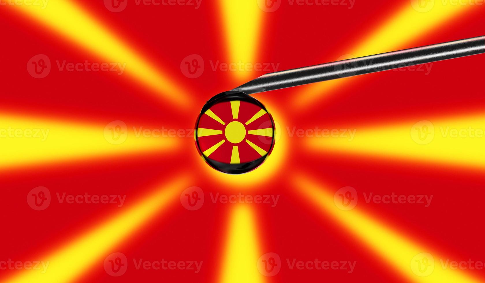 Vaccine syringe with drop on needle against national flag of Macedonia background. Medical concept vaccination. Coronavirus Sars-Cov-2 pandemic protection. National safety idea. photo