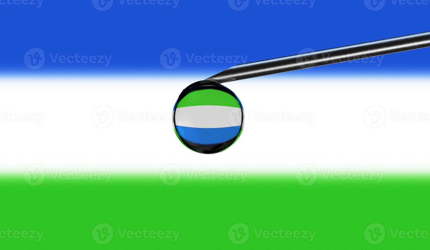 Vaccine syringe with drop on needle against national flag of Sierra Leone background. Medical concept vaccination. Coronavirus Sars-Cov-2 pandemic protection. National safety idea. photo