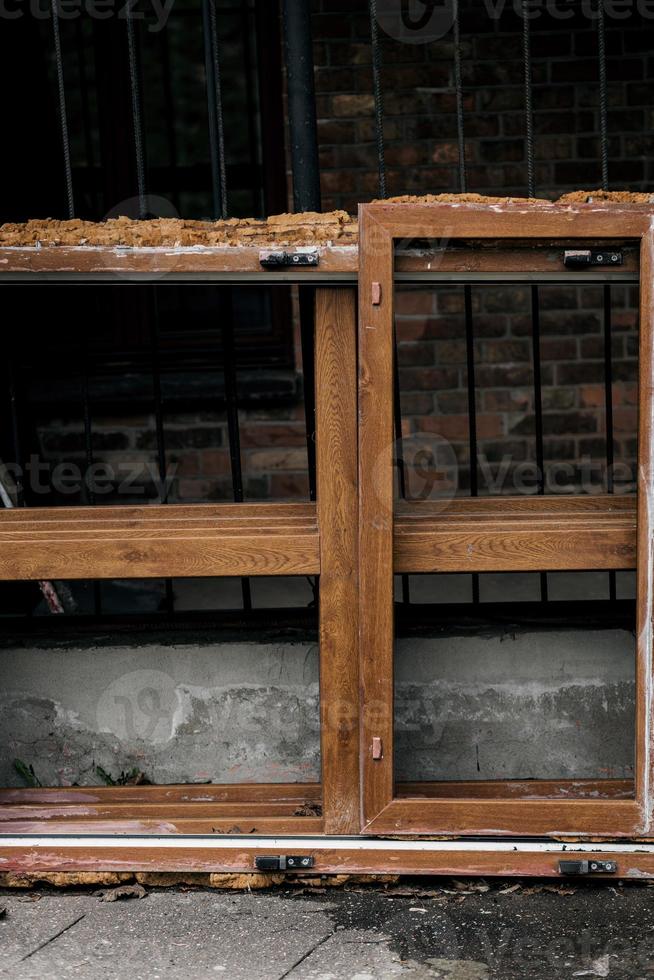 broken old window next to a ruined house photo