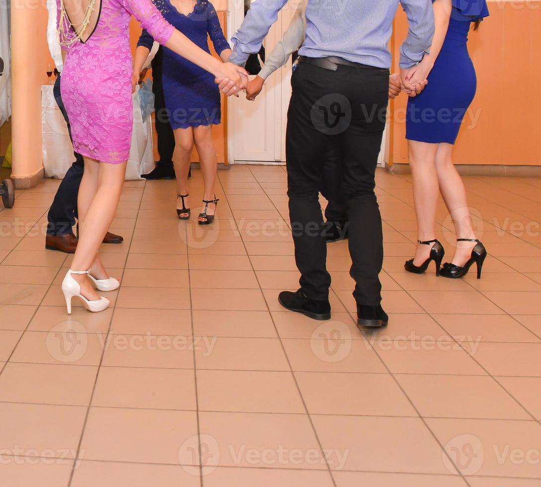People dancing at the wedding party. focus on legs photo