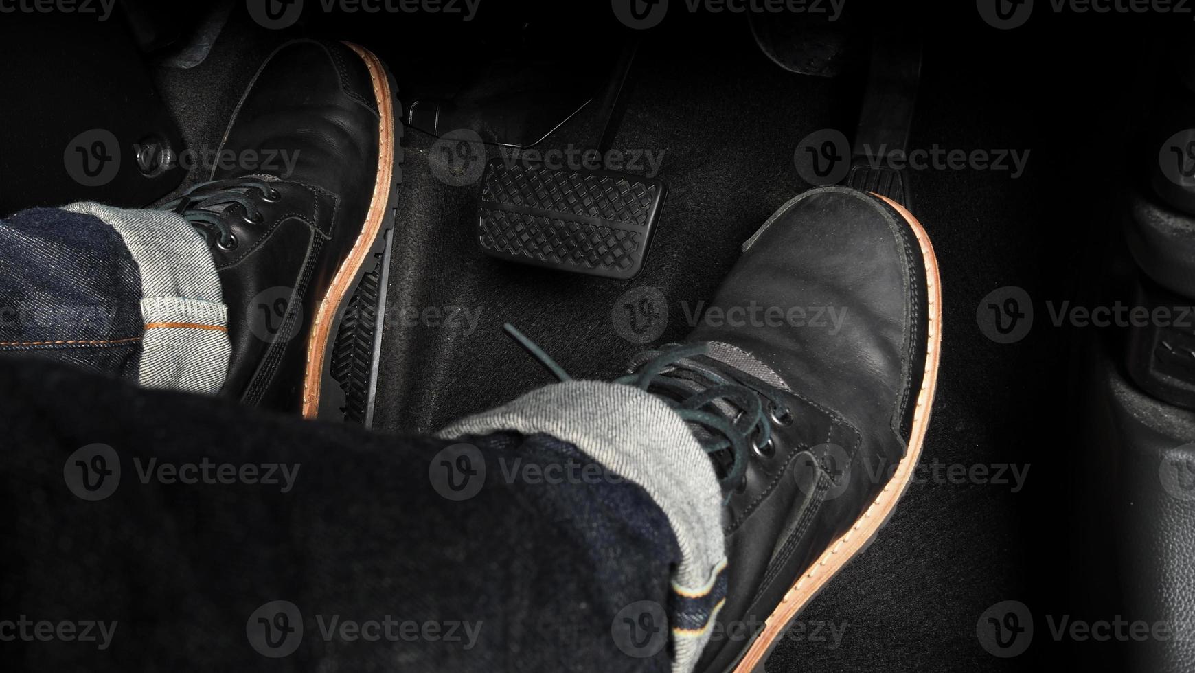 Close up foot press or push foot break and accelerate pedal of a car to drive ahead. photo