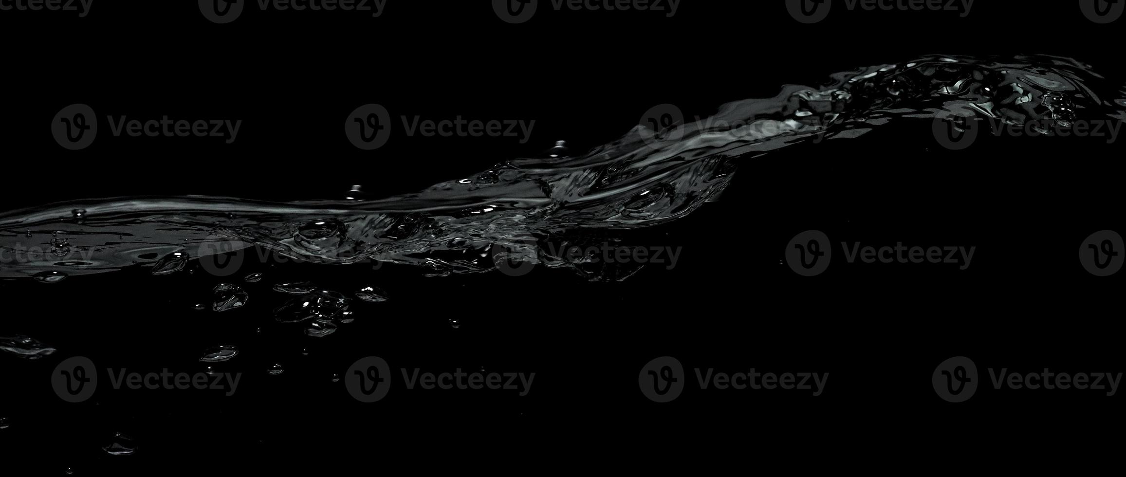 Liquid suface line between underwater and above water with black background. photo