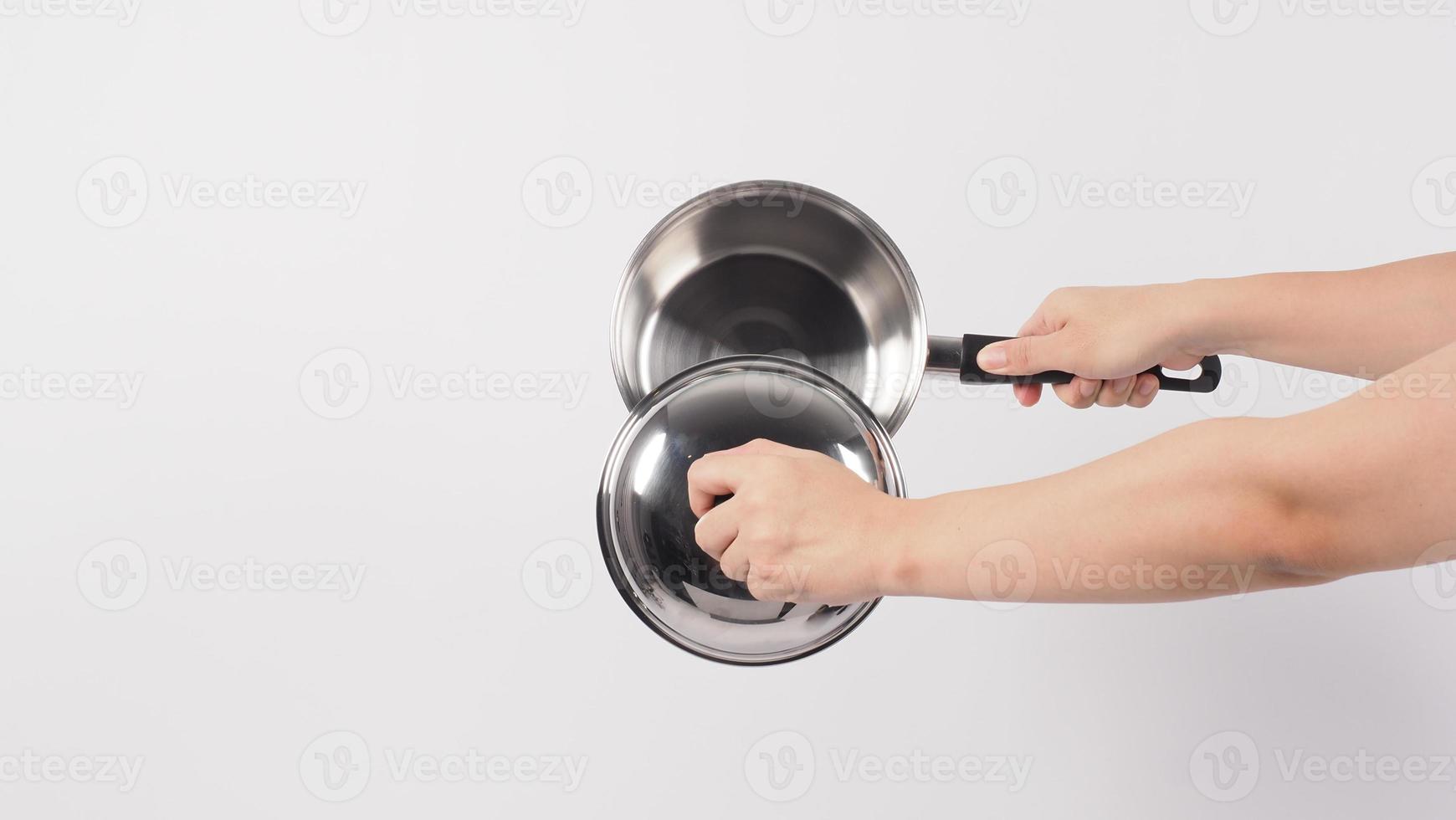 Pot cleaning Man hand on white background cleaning the non stick pot photo