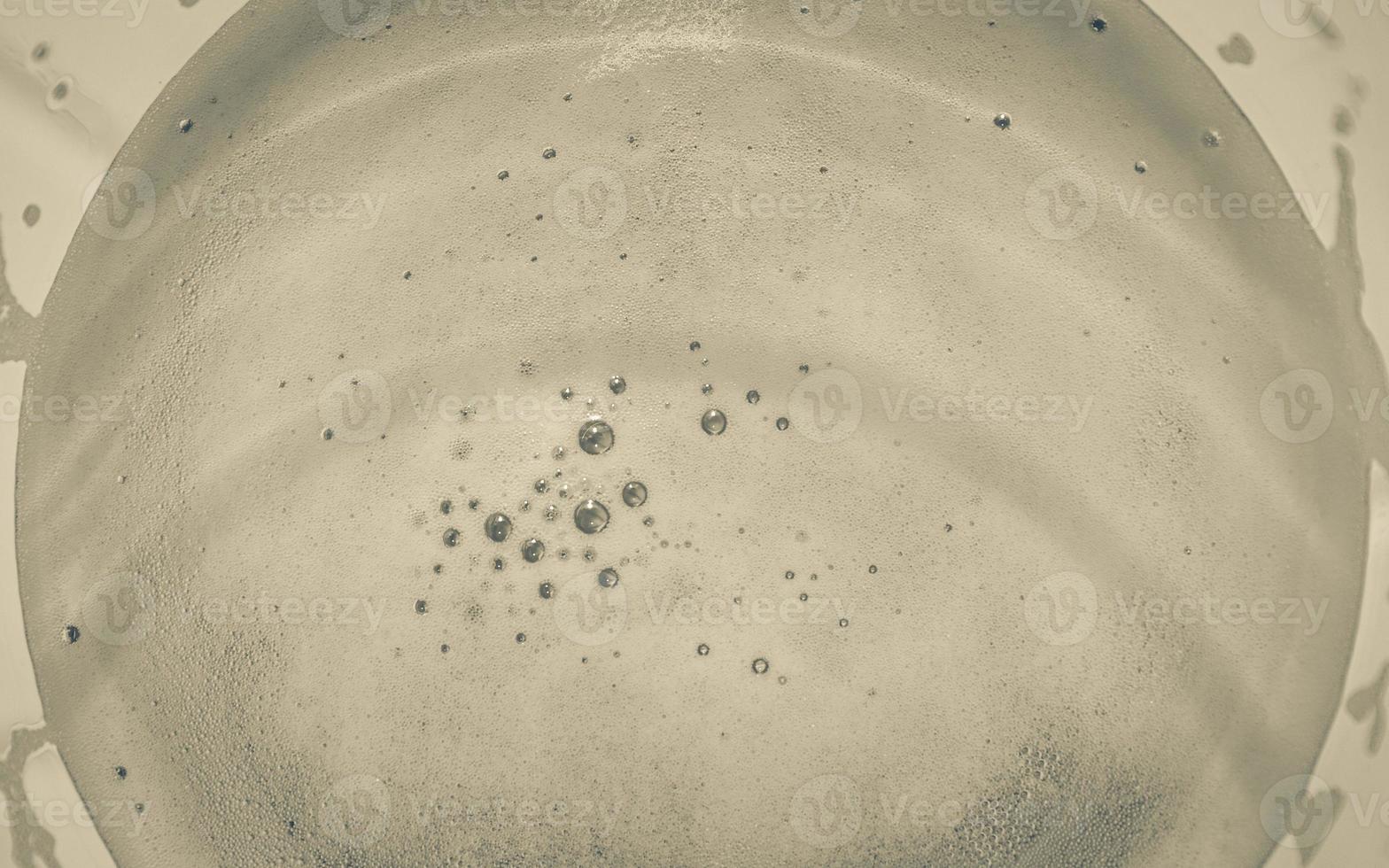 Glass with golden beer seen from above. photo