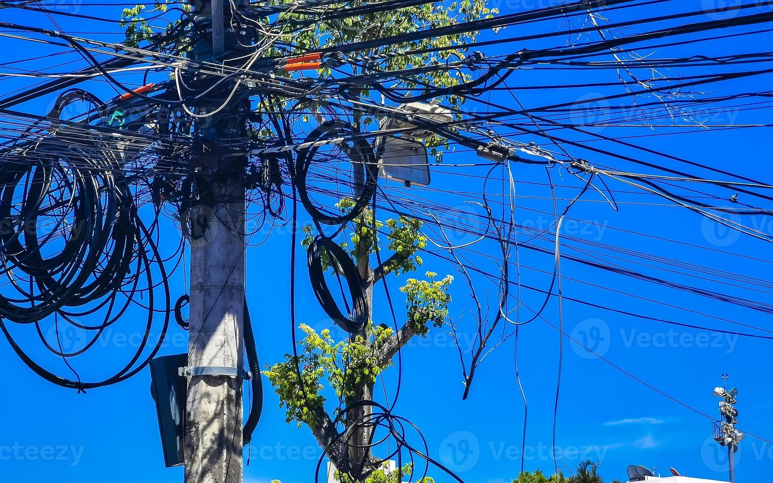 Absolute cable chaos on Thai power pole in Mexico. photo