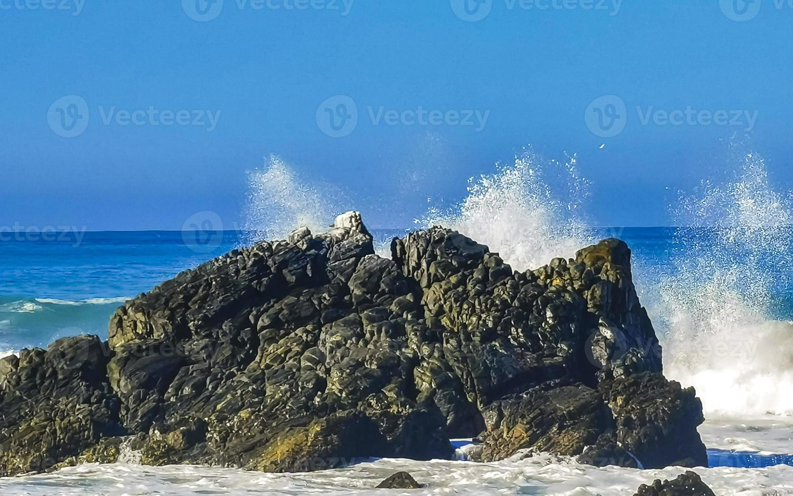 Beautiful rocks cliffs surfer waves at beach Puerto Escondido Mexico. photo