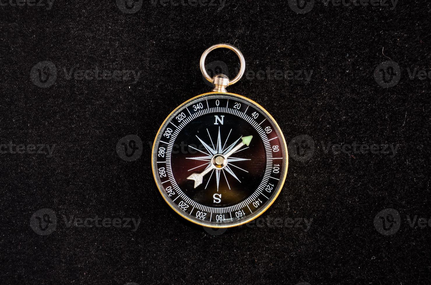 Compass on black background photo