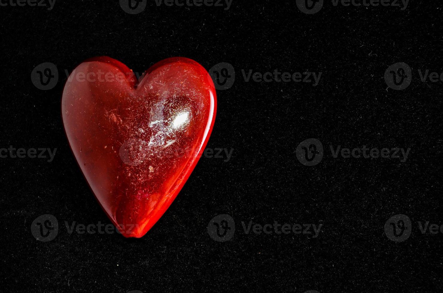 Red heart on black background photo