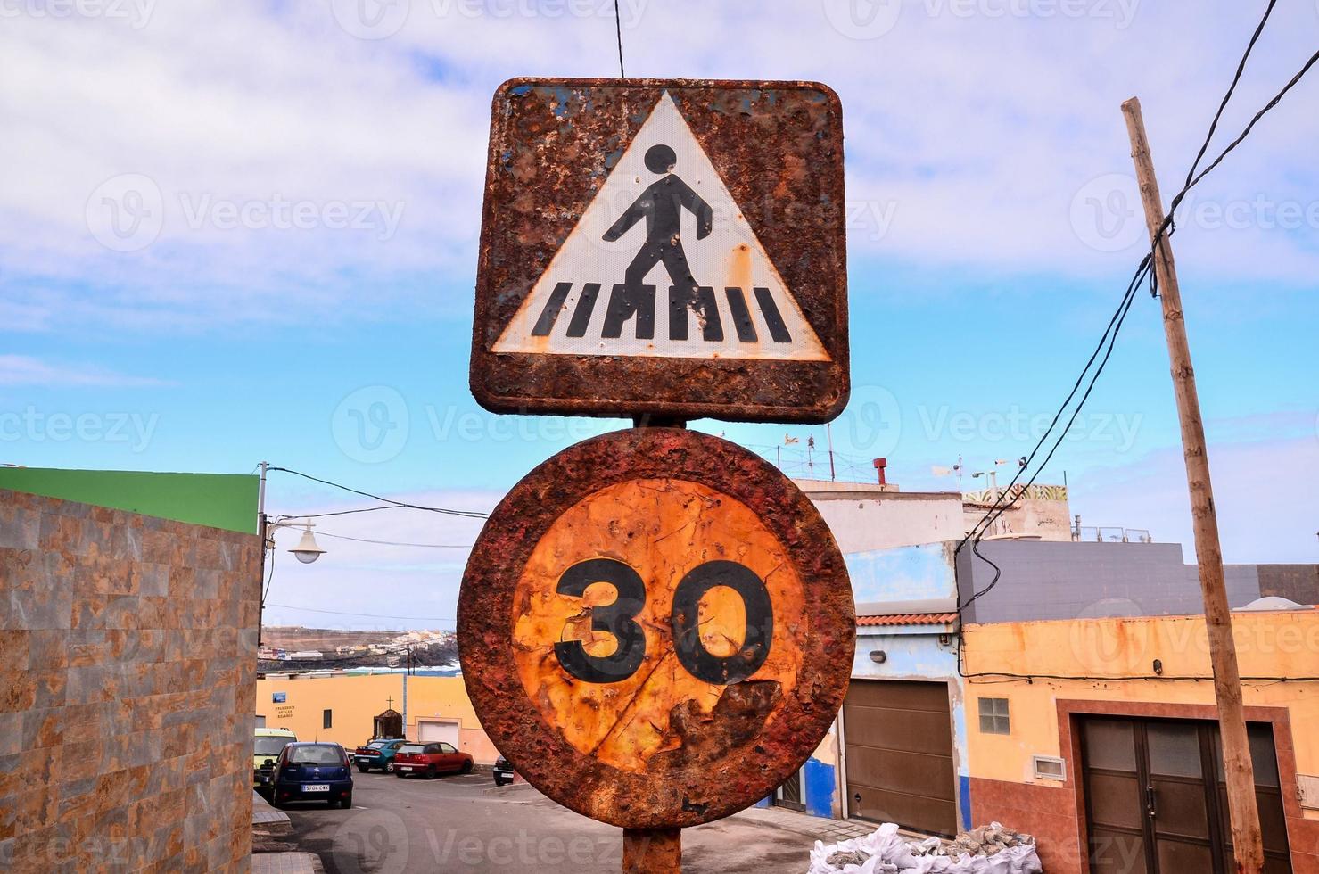 Corroded traffic signs on the street photo