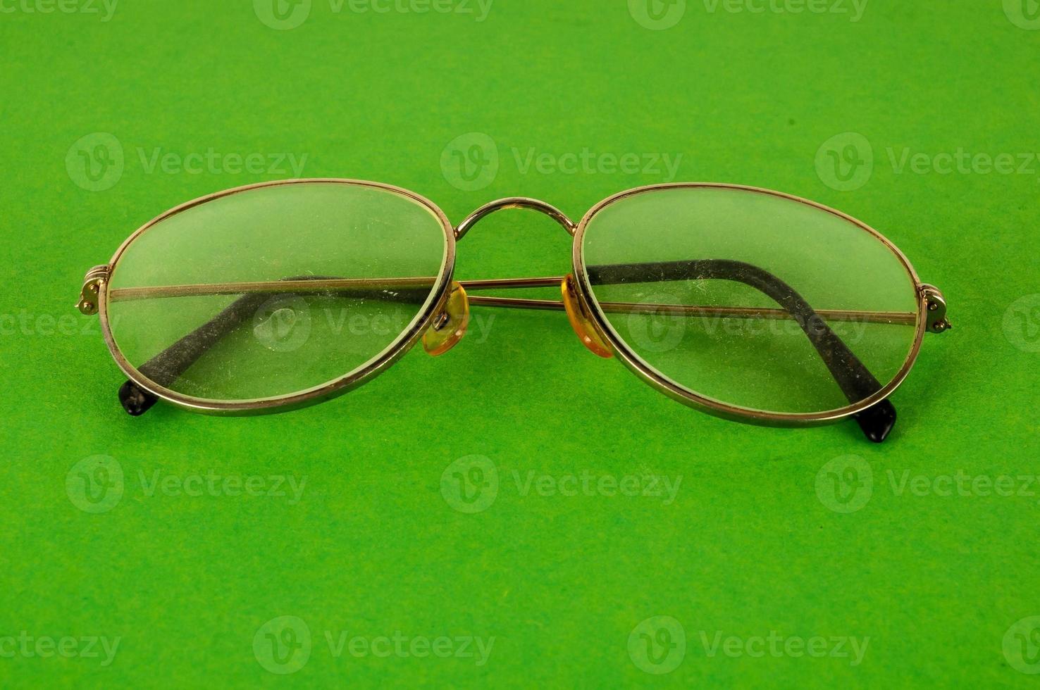 Glasses on green background photo