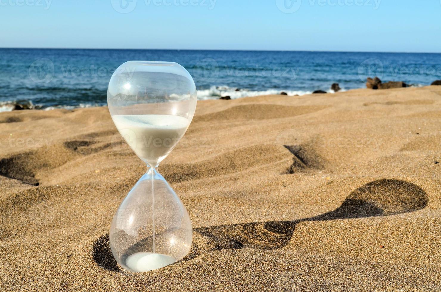 Hourglass on the ground photo