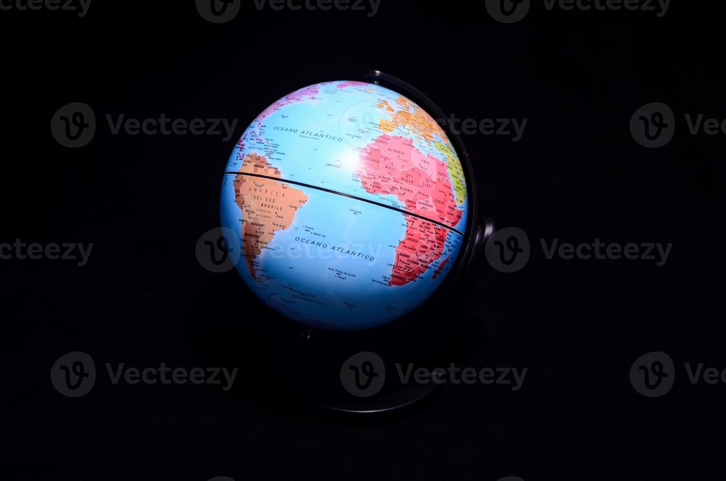 Globe on black background photo