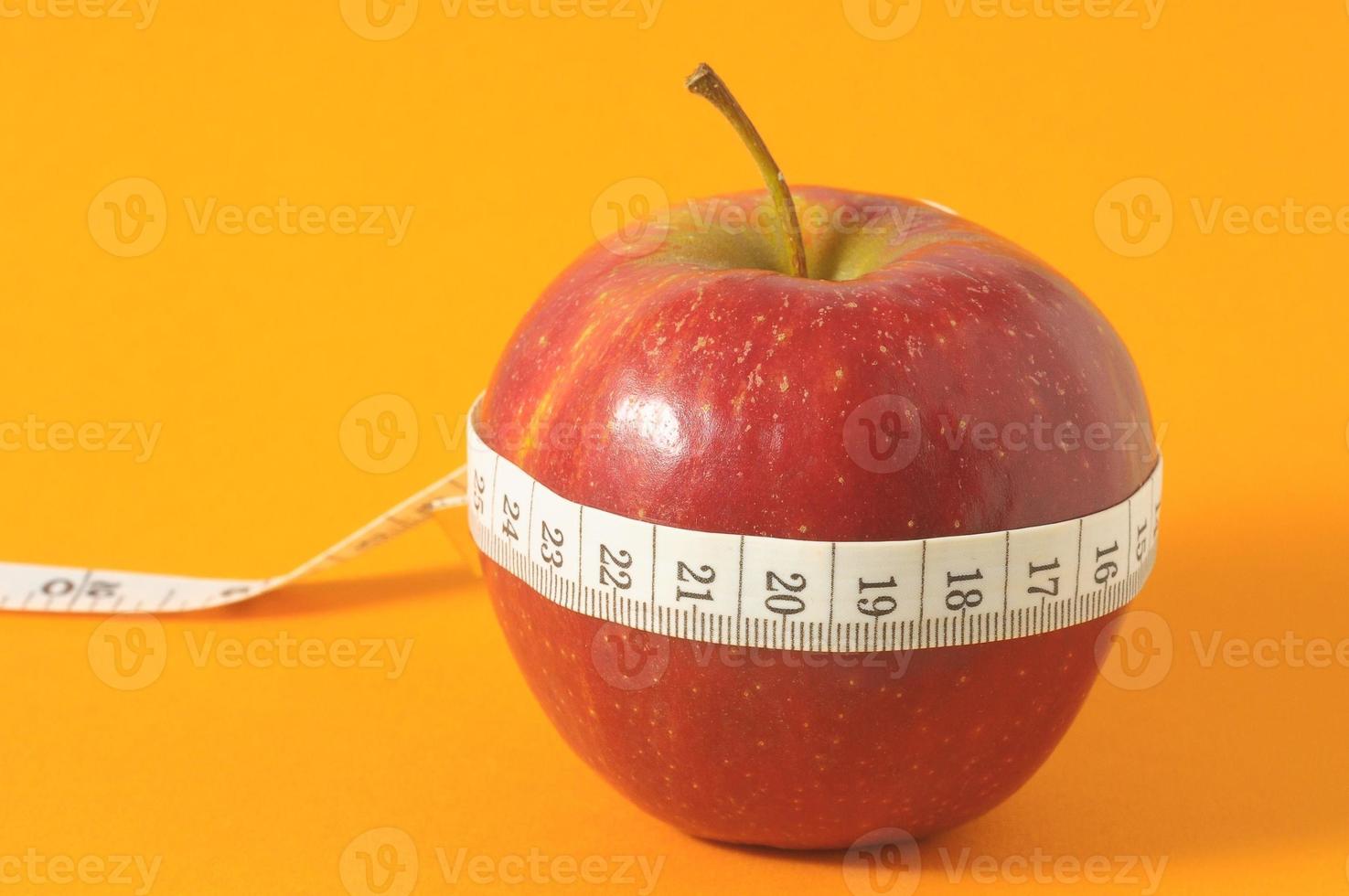 Apple with a measuring tape photo
