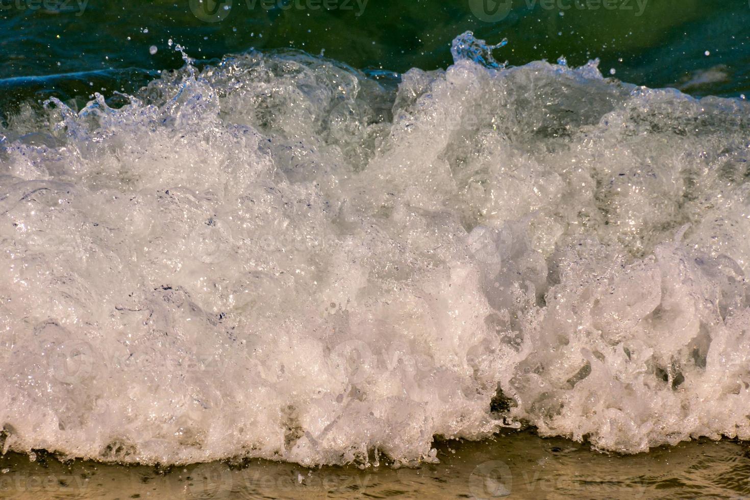 Waves crashing at the shore photo