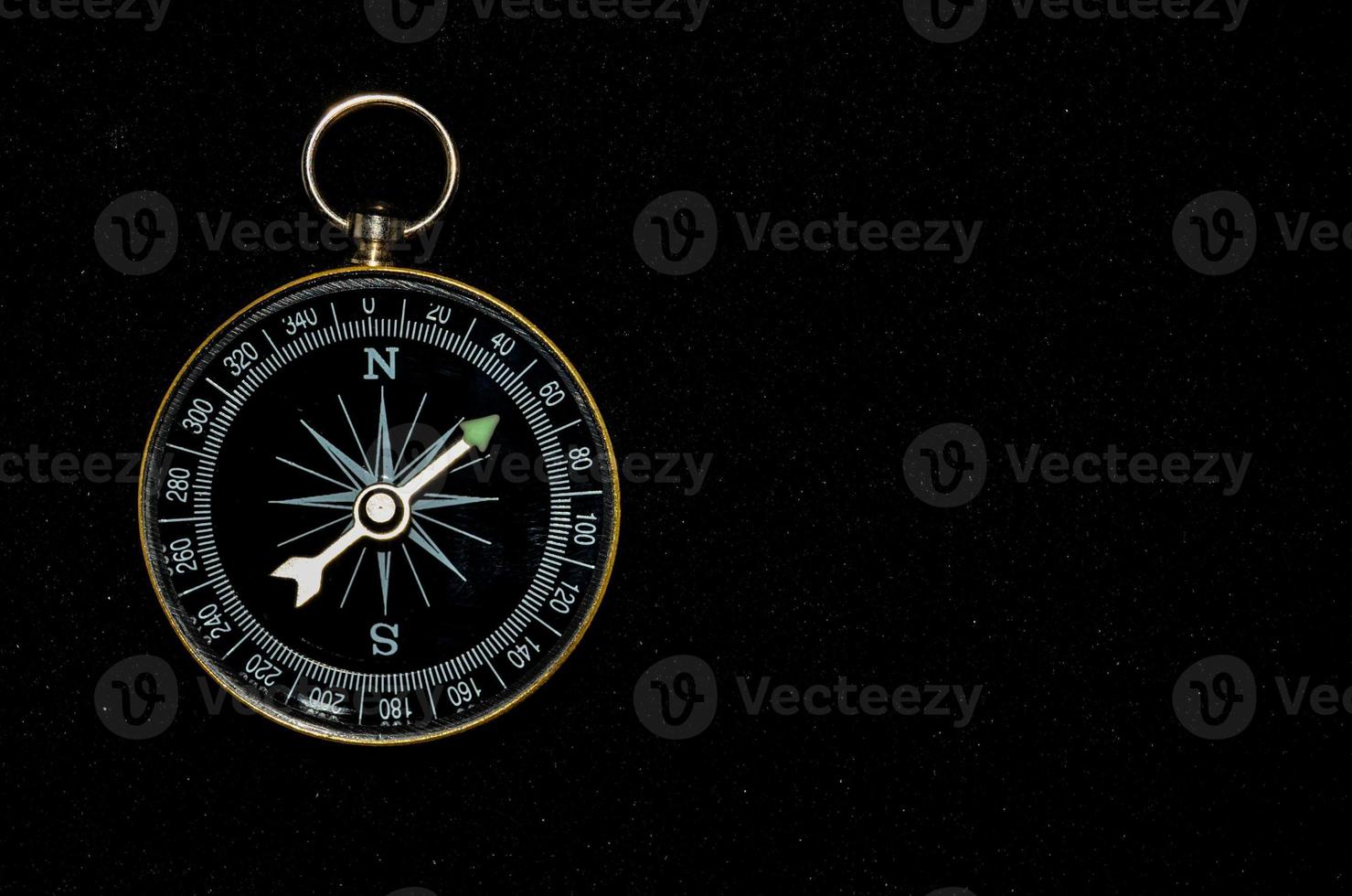 Compass on black background photo