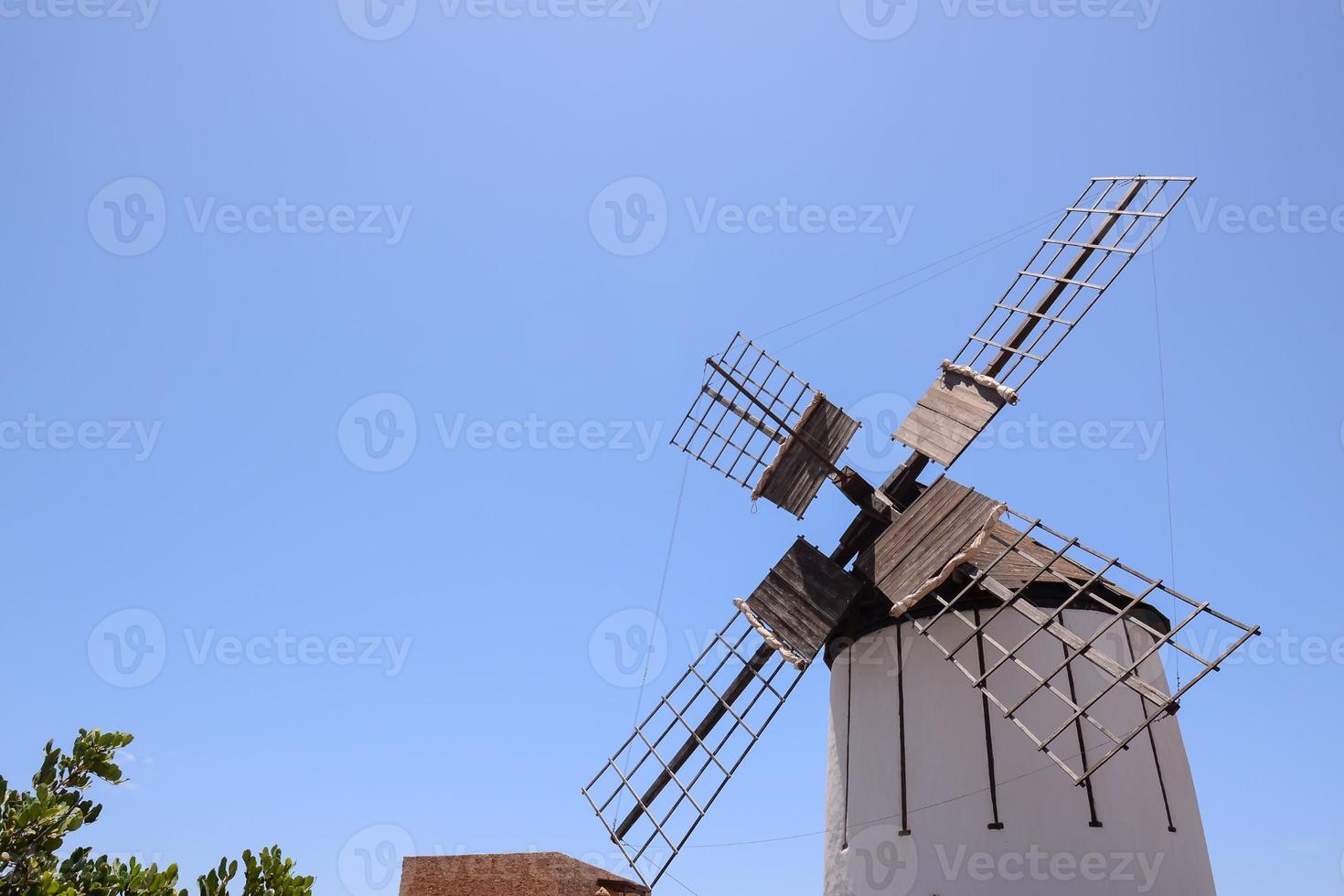 Traditional windmill under clear blue sky photo