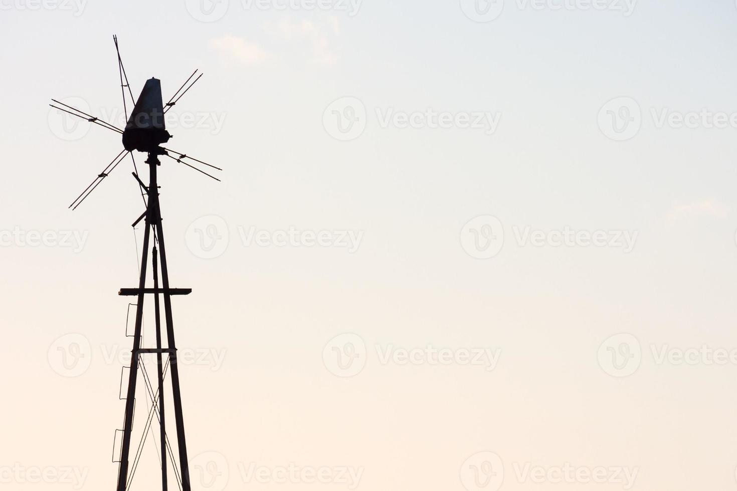 Traditional windmill under clear blue sky photo