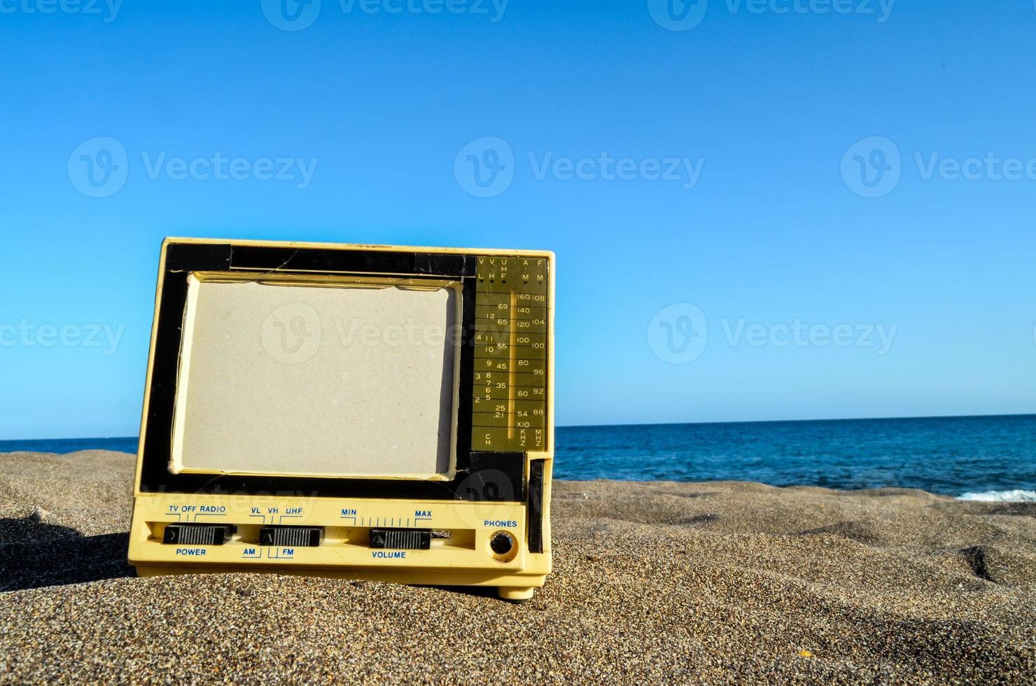 Old television in the sand photo