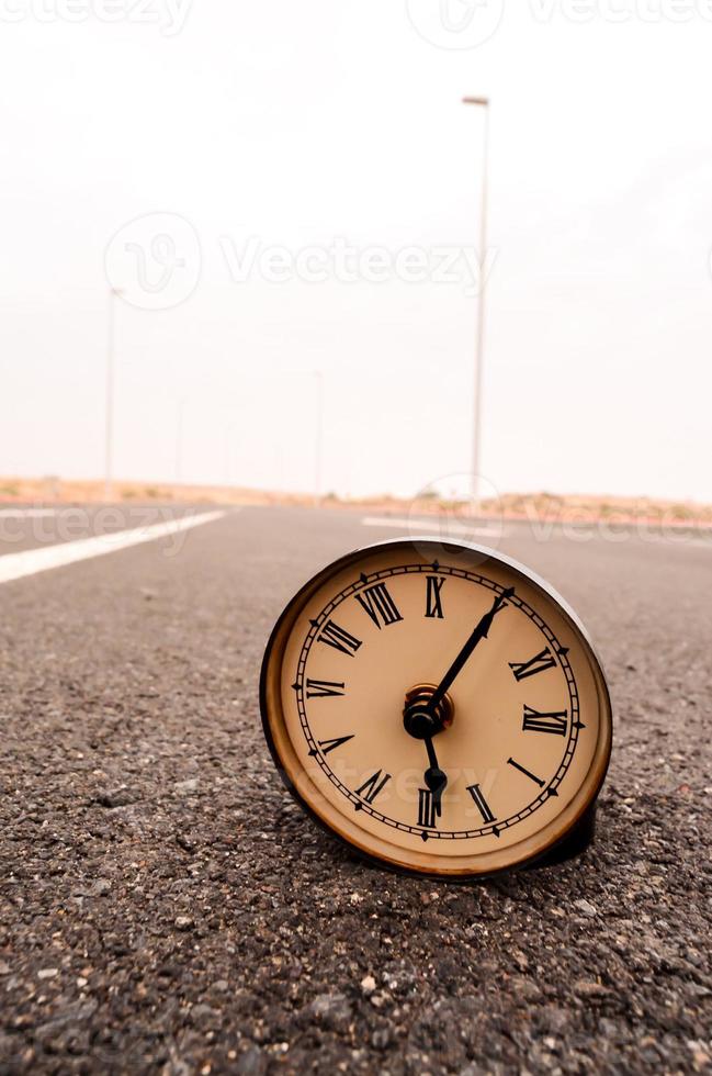 Clock on the road photo