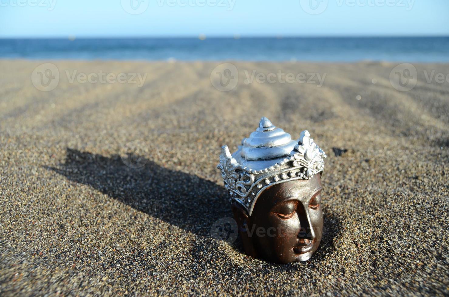 Small statue on the beach photo
