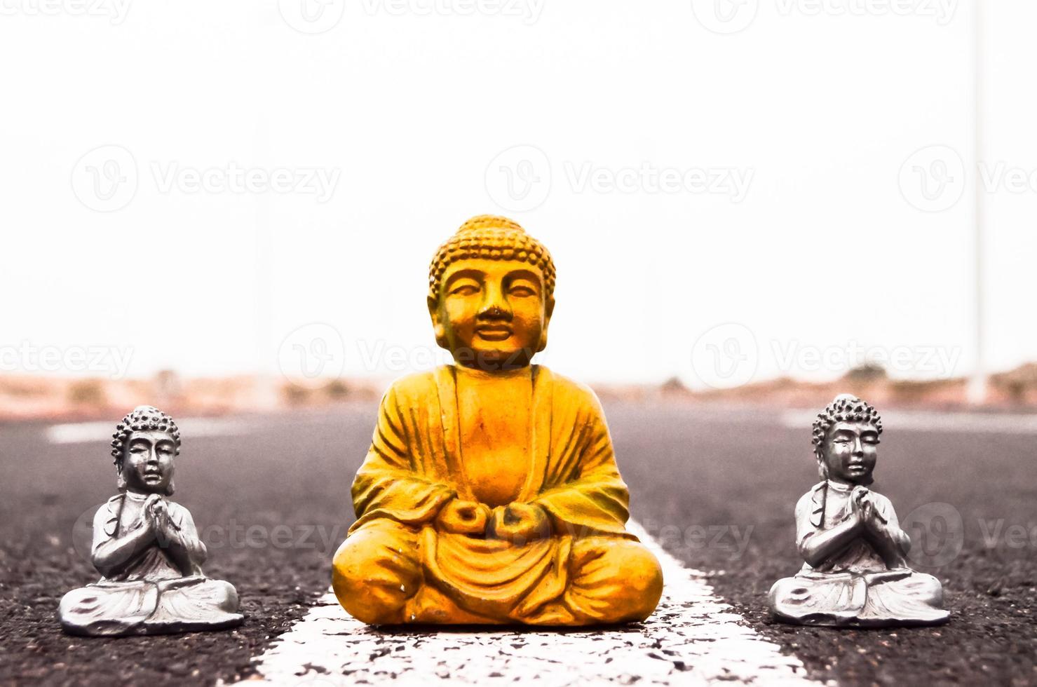 Small Buddha statues on the road photo