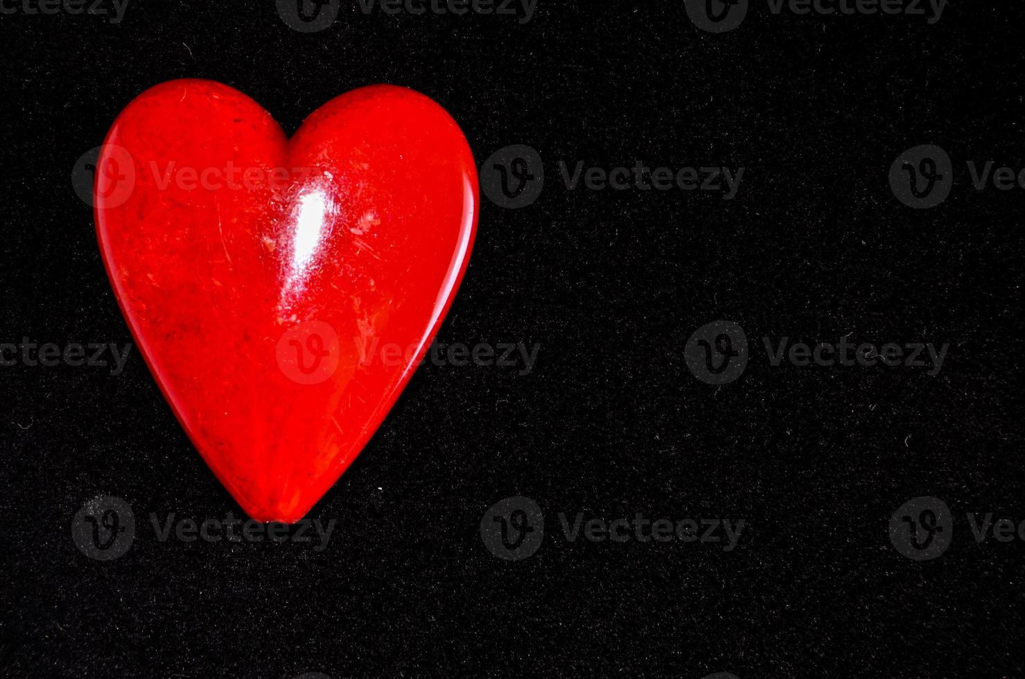 Red heart on black background photo