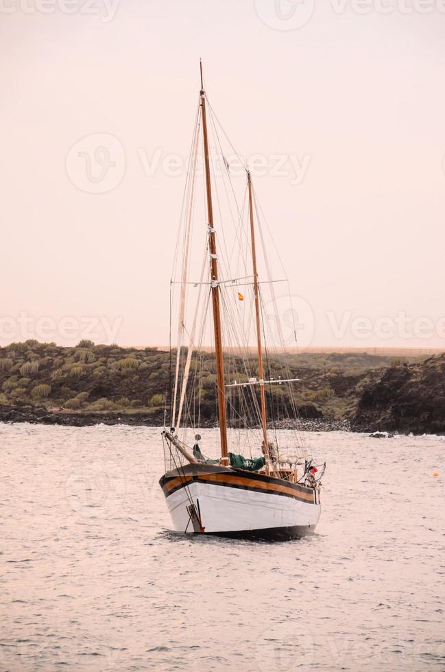 Sailing boat by the shore photo