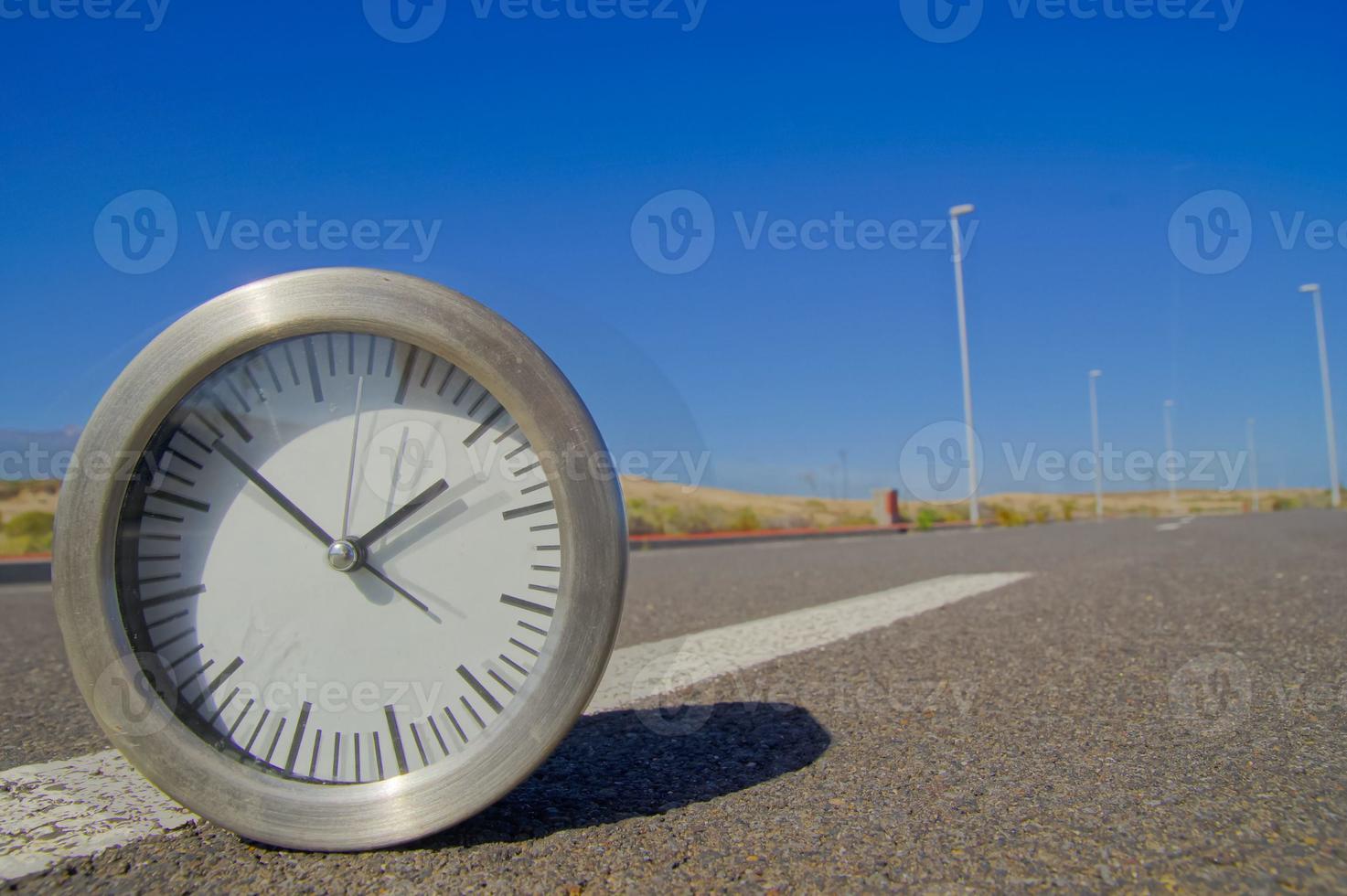 Clock on the road photo