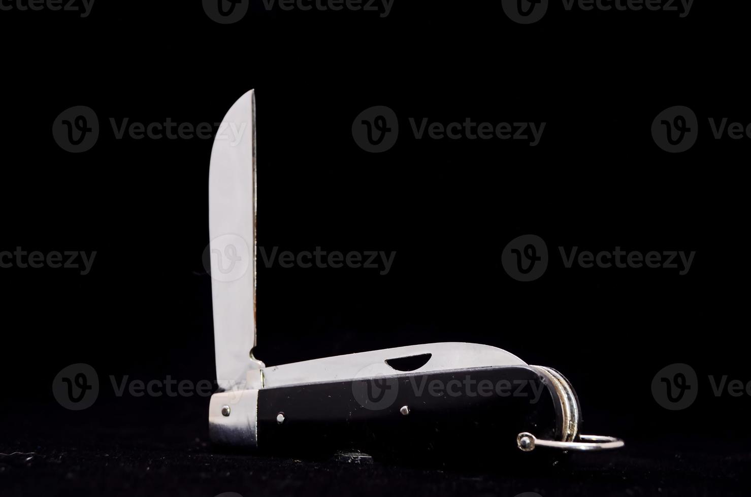 Pocket knife on black background photo