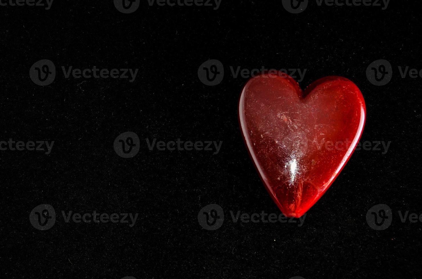 Red heart on black background photo