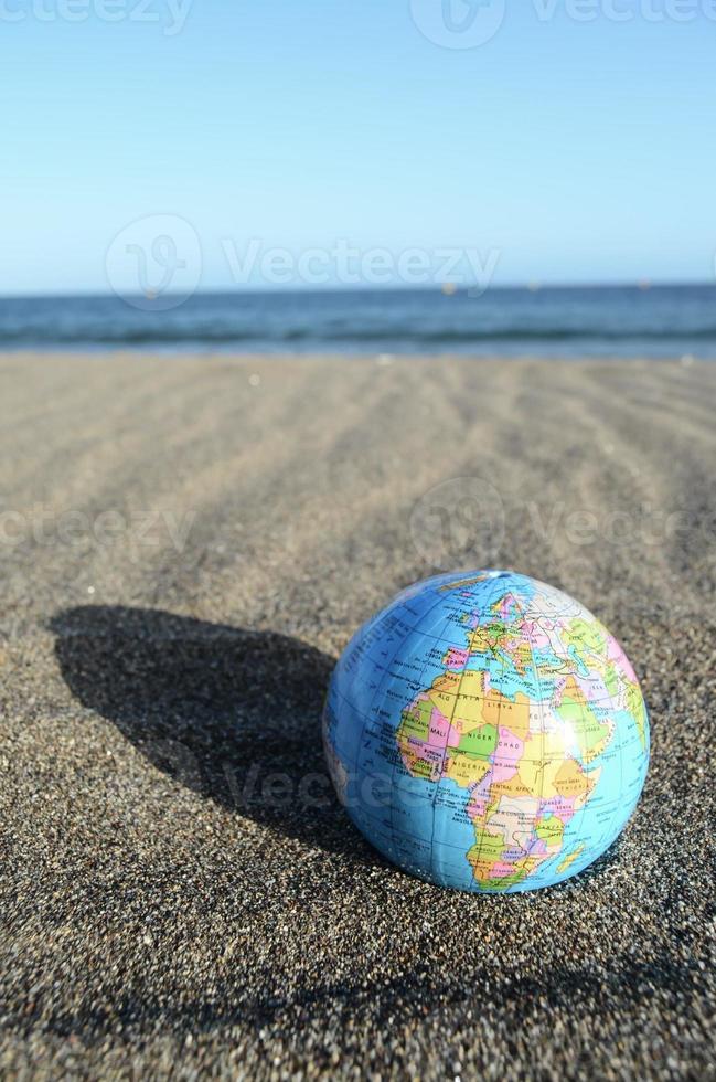 Globe in the sand photo