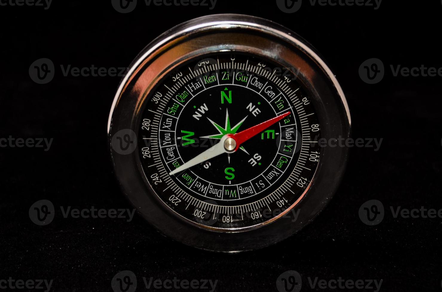 Isolated compass on black background photo