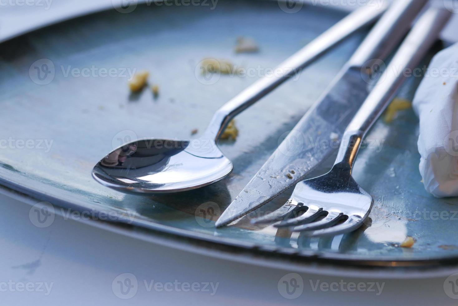 Empty plate after eating on table photo